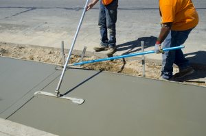 Workers laying concrete for a foundation in Flower Mound