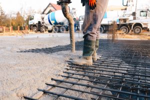 Concrete worker laying a foundation for a business in Flower Mound